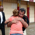 Anna Long of Pennsylvania gives Governor Chris Christie a hug while he was touring the section of boardwalk
